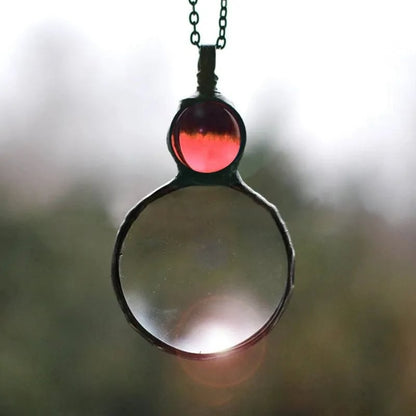 Necklace Featuring a Magnifying Pendant
