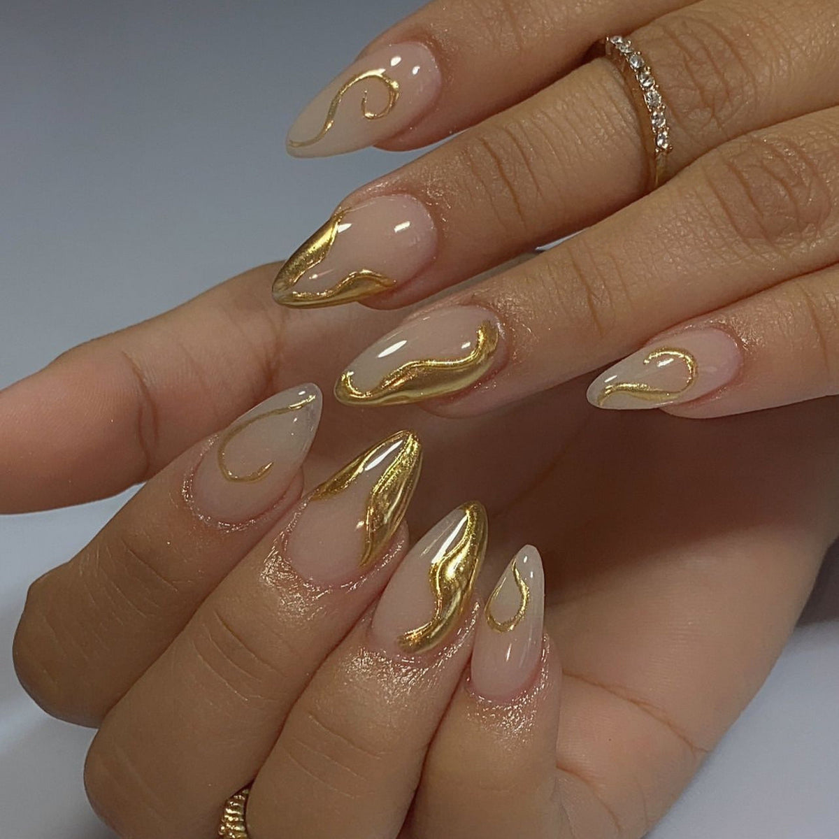 Elegant Nail Design with Stiletto Shape and Gold Details